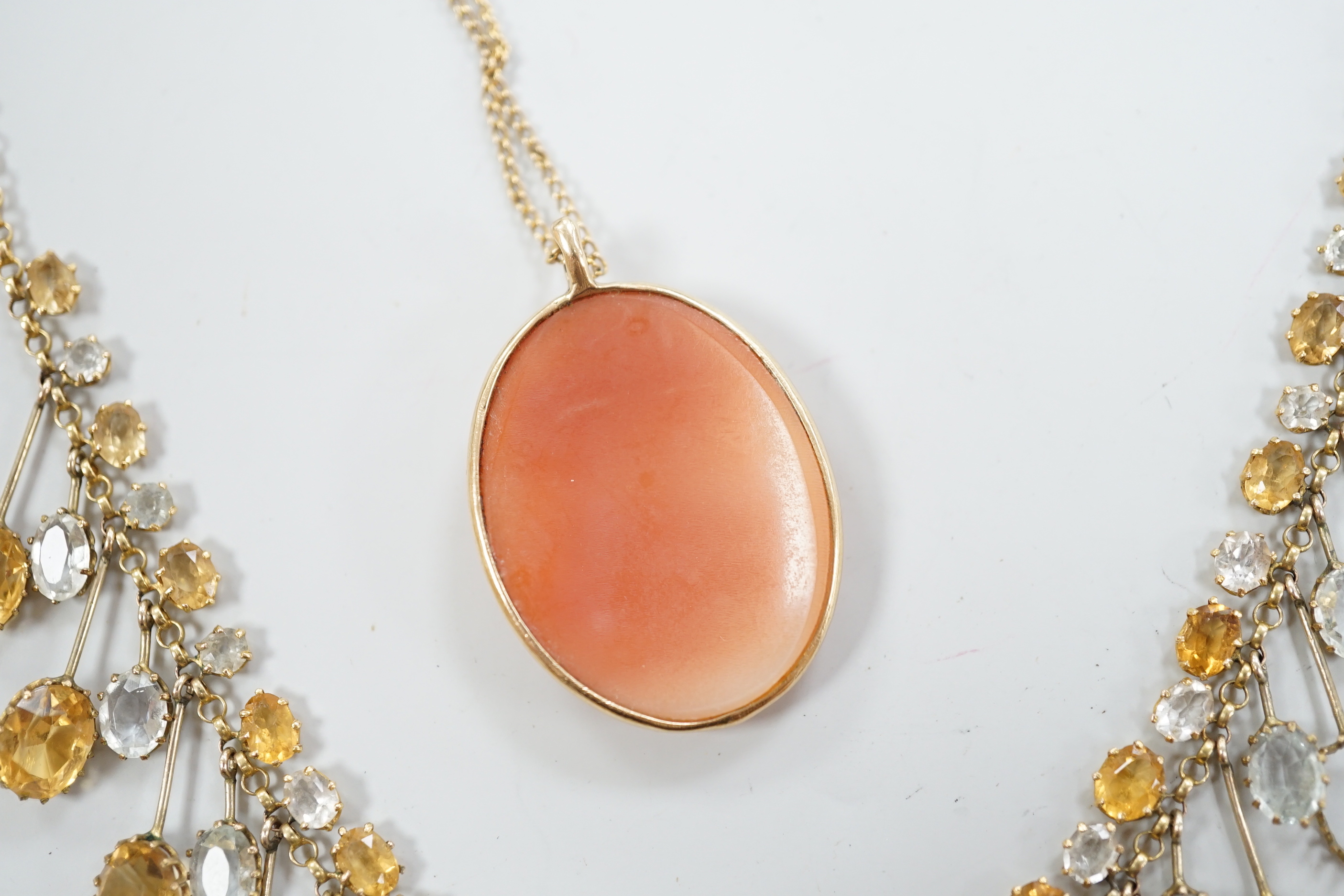 A yellow metal mounted oval cameo shell pendant, on a 9ct chain, together with a citrine and colourless beryl? set drop fringe necklace(a.f.).